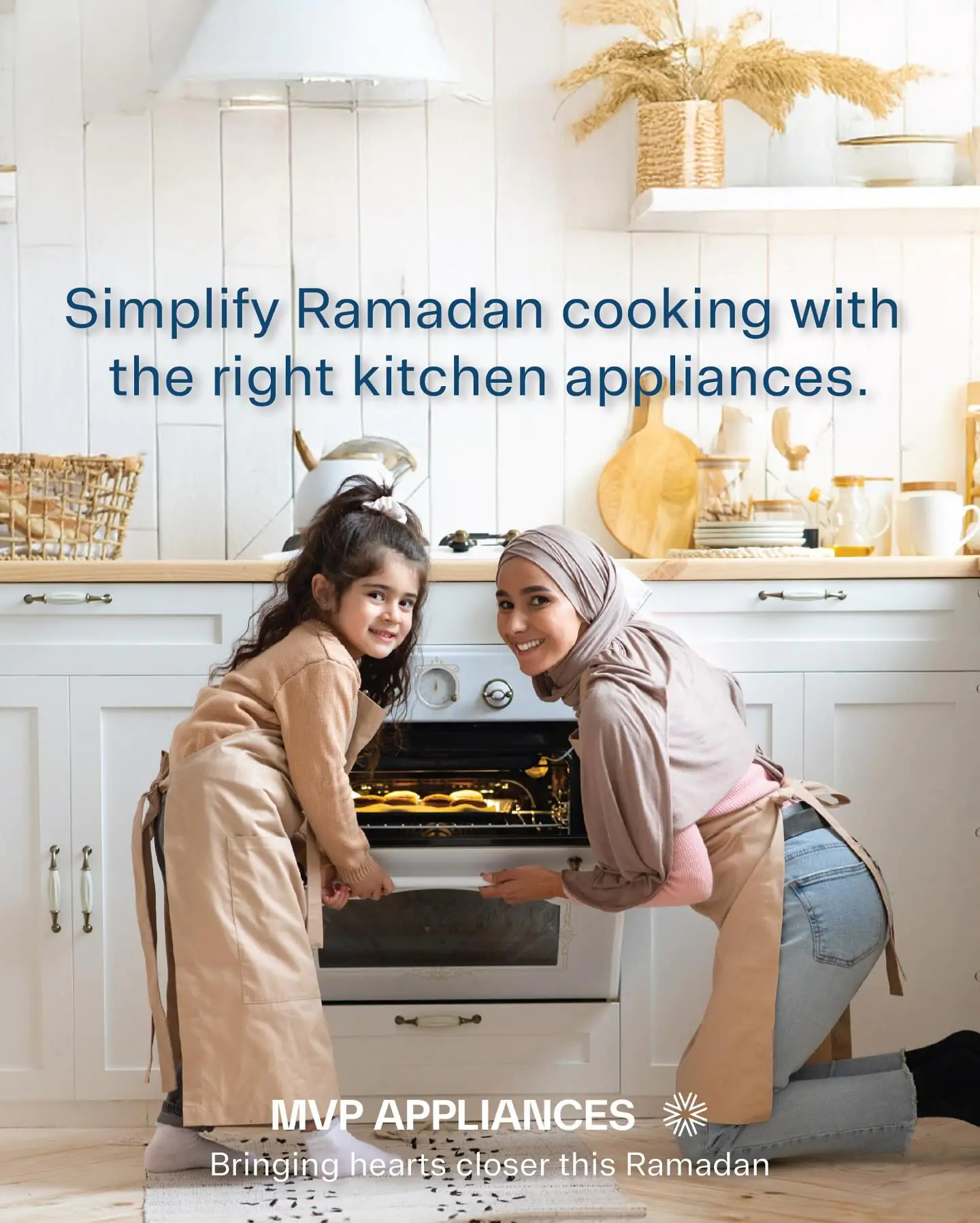 A joyful mother and daughter baking cookies in a kitchen, with an oven from MVP Appliances in the background.